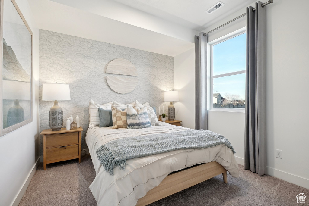 Bedroom featuring carpet, baseboards, and wallpapered walls