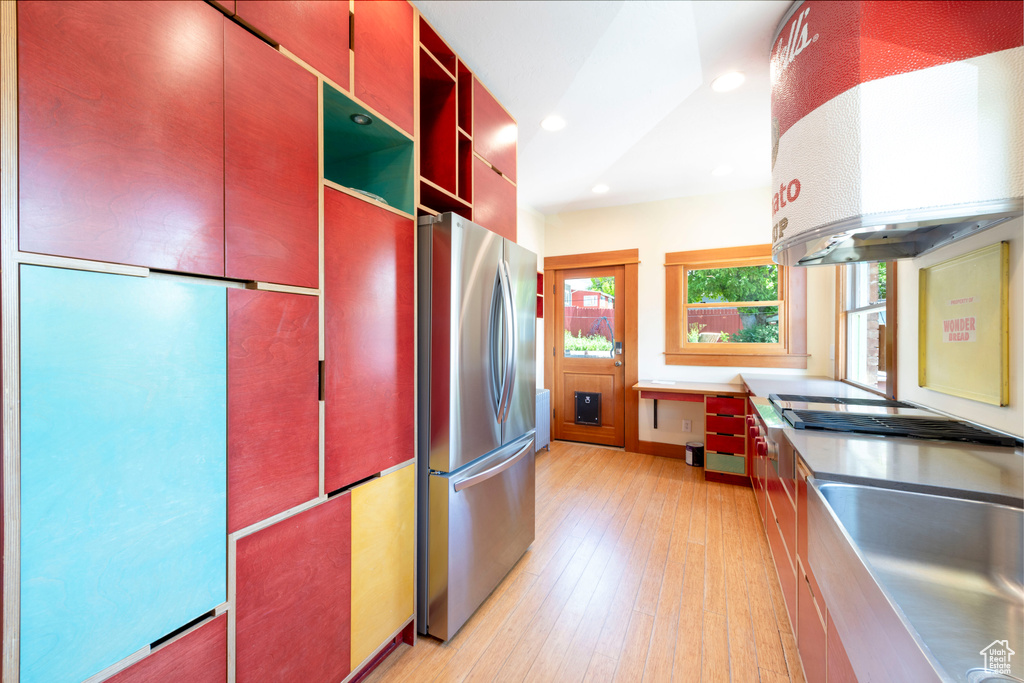 Kitchen with stainless steel appliances, ventilation hood, recessed lighting, open shelves, and light wood-type flooring