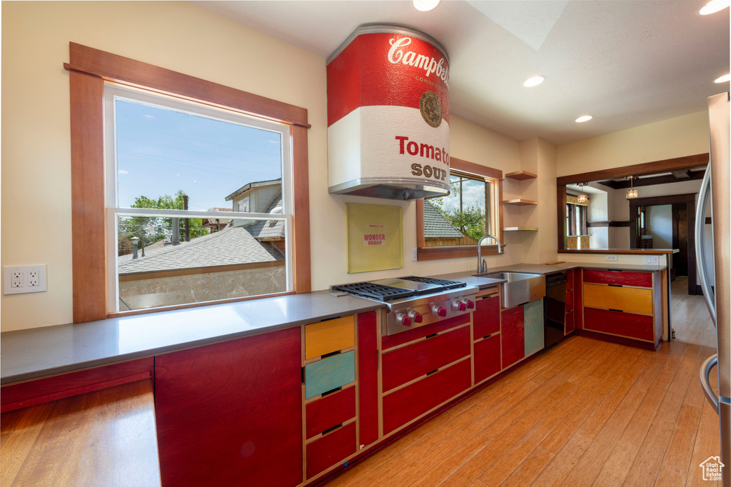 Kitchen featuring stainless steel gas stovetop, a sink, plenty of natural light, light wood-type flooring, and recessed lighting