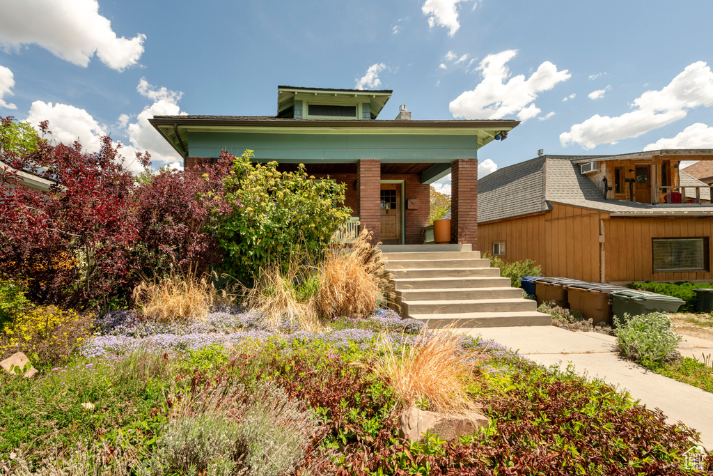 View of front of house featuring covered porch and stairway