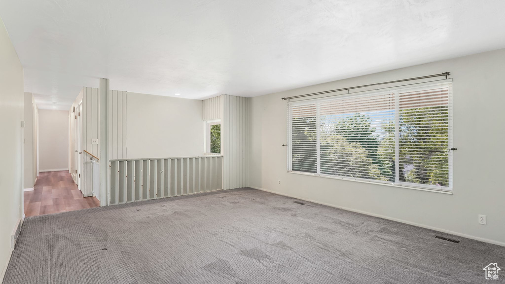 Carpeted empty room featuring baseboards