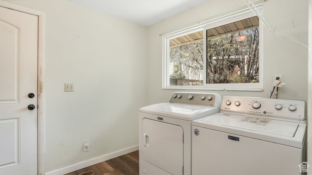 Washroom with independent washer and dryer, baseboards, and dark wood-type flooring