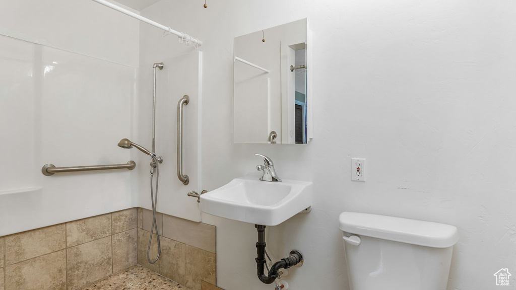 Bathroom featuring a shower and toilet