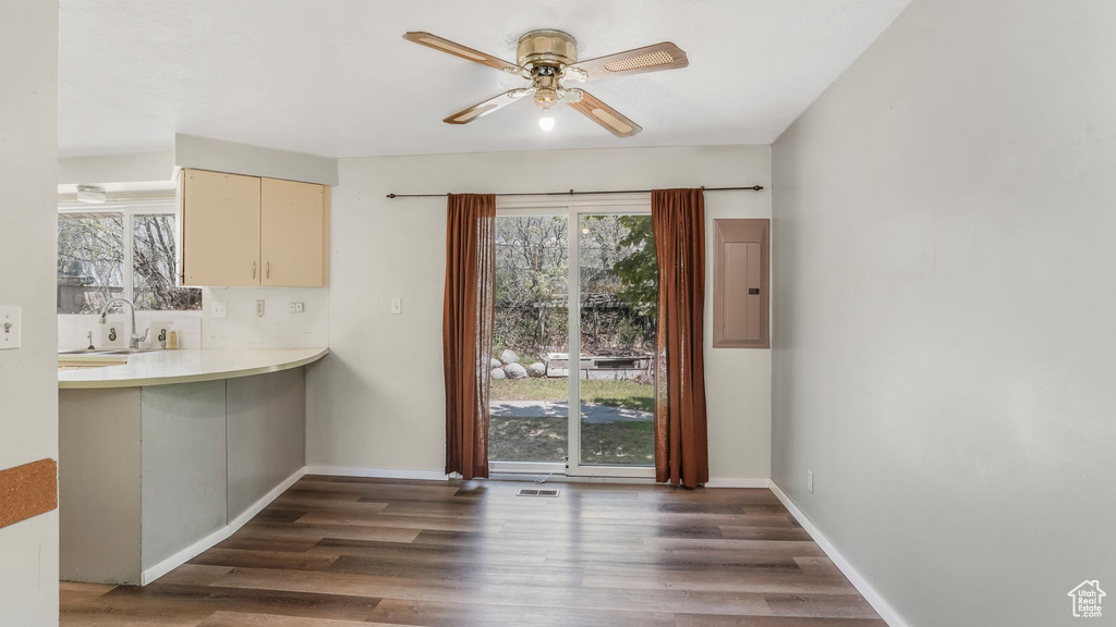 Unfurnished dining area featuring ceiling fan, healthy amount of natural light, and wood finished floors