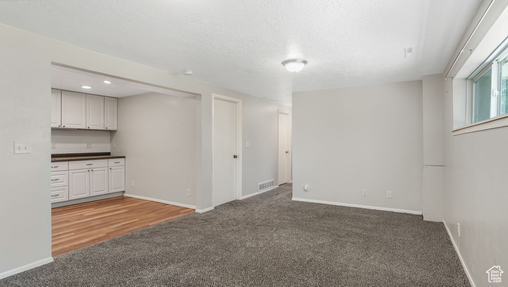 Basement featuring light carpet, baseboards, and recessed lighting