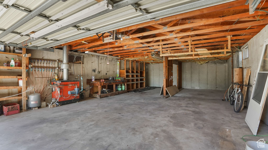 Garage with a workshop area and a heating unit