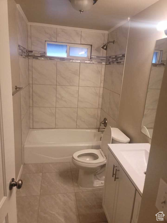 Full bathroom with shower / tub combination, toilet, vanity, and tile patterned floors