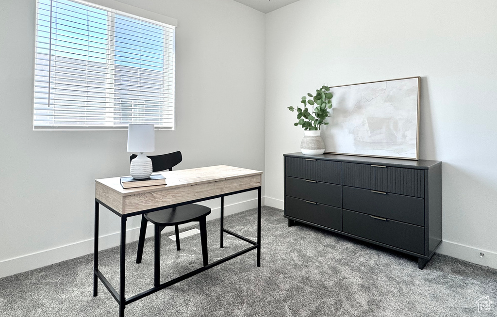 Carpeted office space featuring baseboards