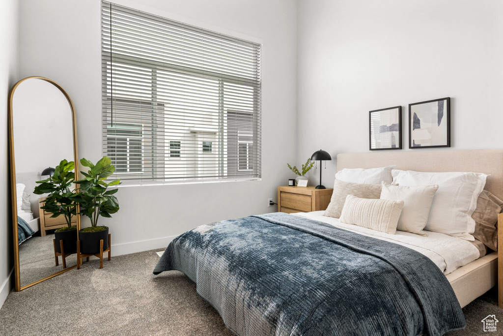Carpeted bedroom featuring baseboards