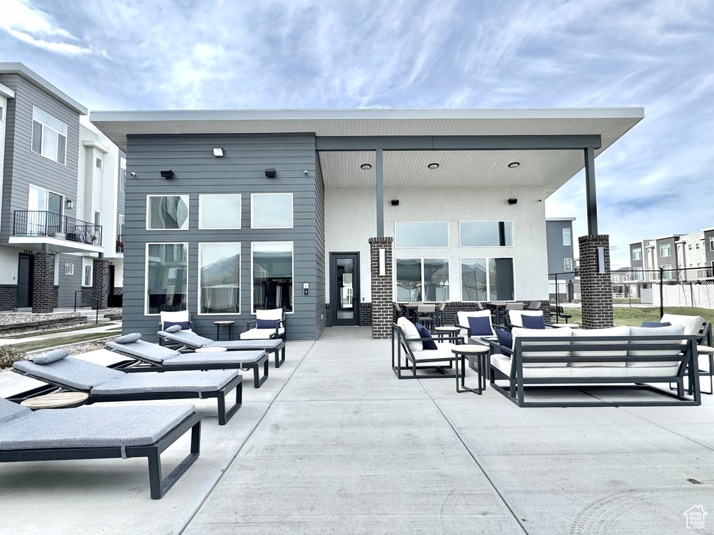 Back of house featuring an outdoor living space and a patio