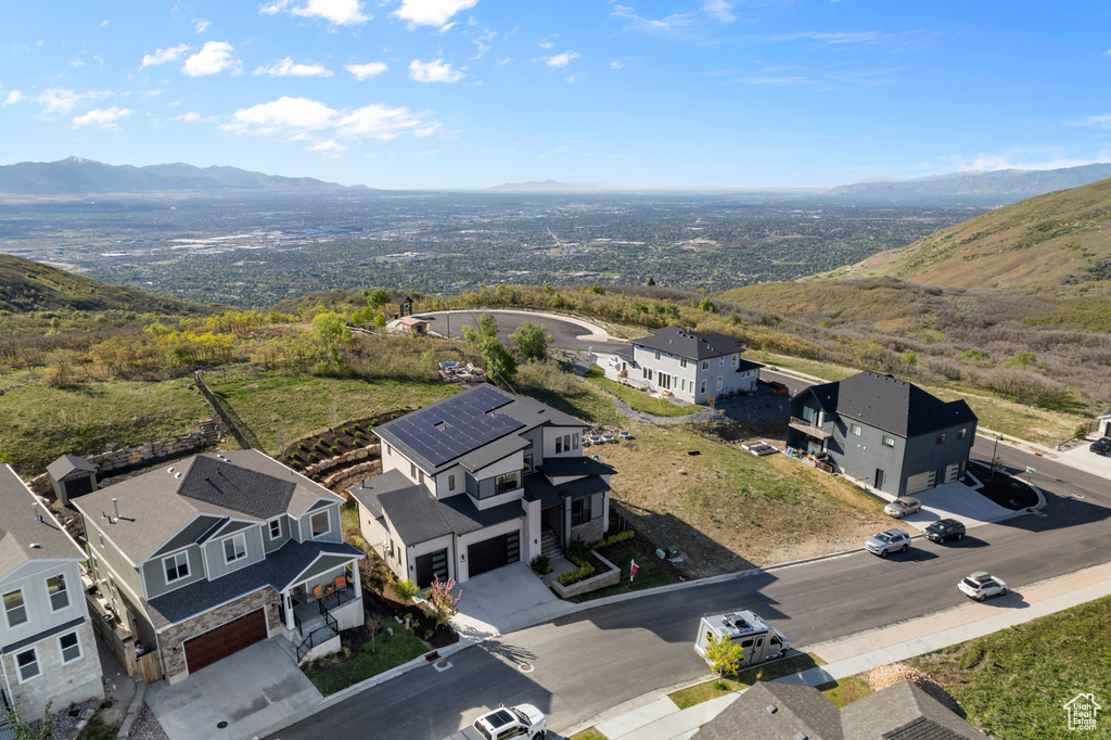Aerial perspective of suburban area featuring a mountain backdrop