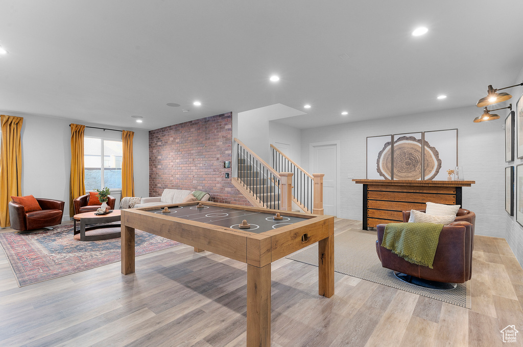 Rec room with light wood finished floors and recessed lighting