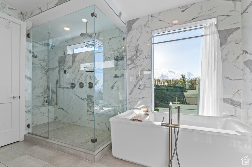 Full bathroom with a marble finish shower, a soaking tub, and recessed lighting