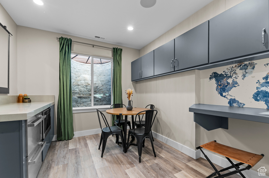 Dining space with light wood-type flooring, baseboards, and recessed lighting