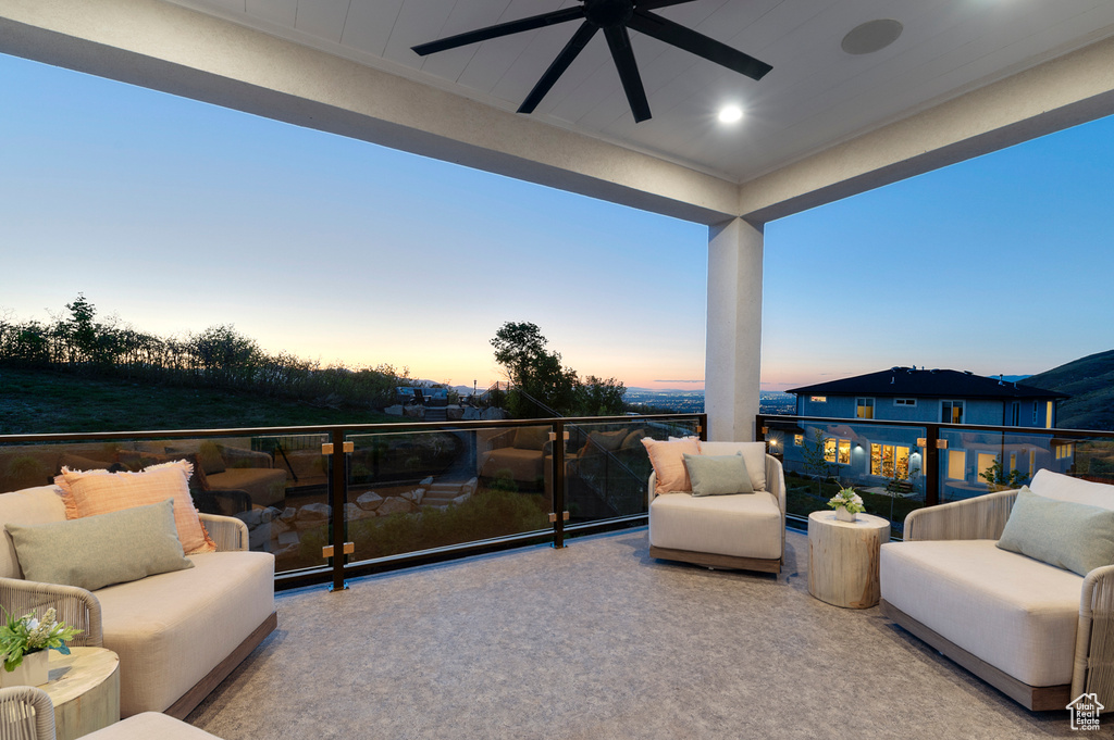 Balcony with a ceiling fan and an outdoor living space