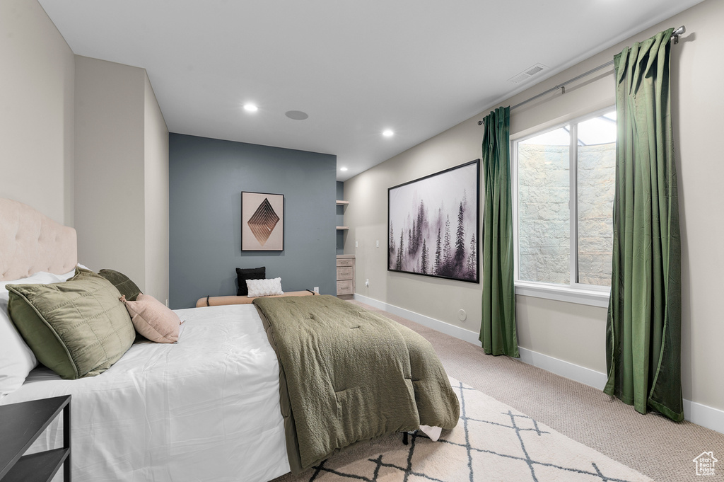 Bedroom with light carpet, baseboards, and recessed lighting