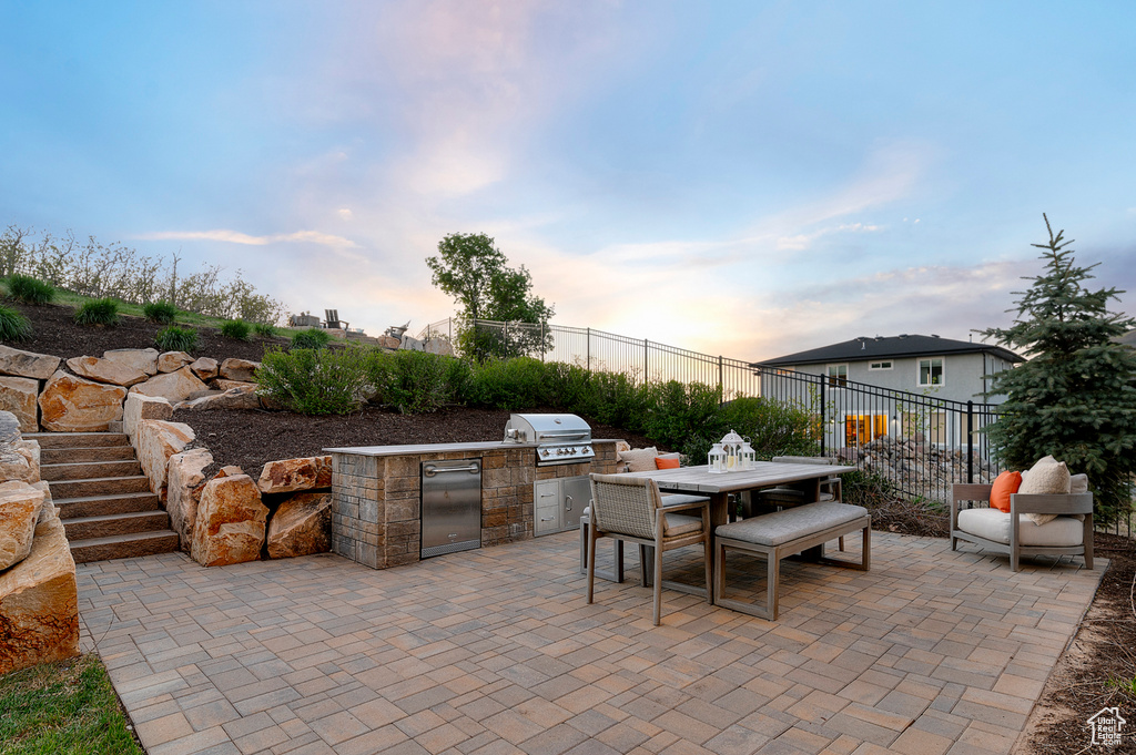 View of patio / terrace with area for grilling, fence, grilling area, and outdoor dining space