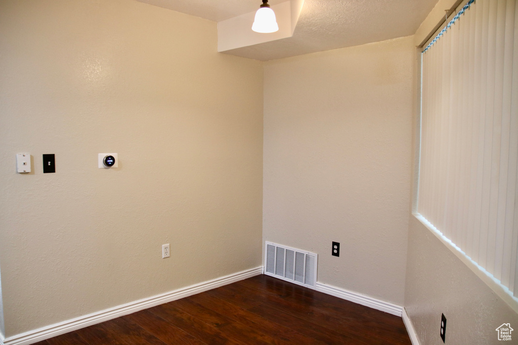 Washroom featuring electric dryer hookup, wood finished floors, and baseboards