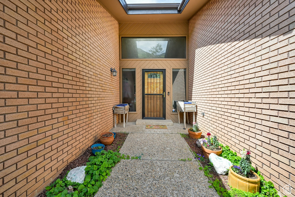 Entrance to property with brick siding