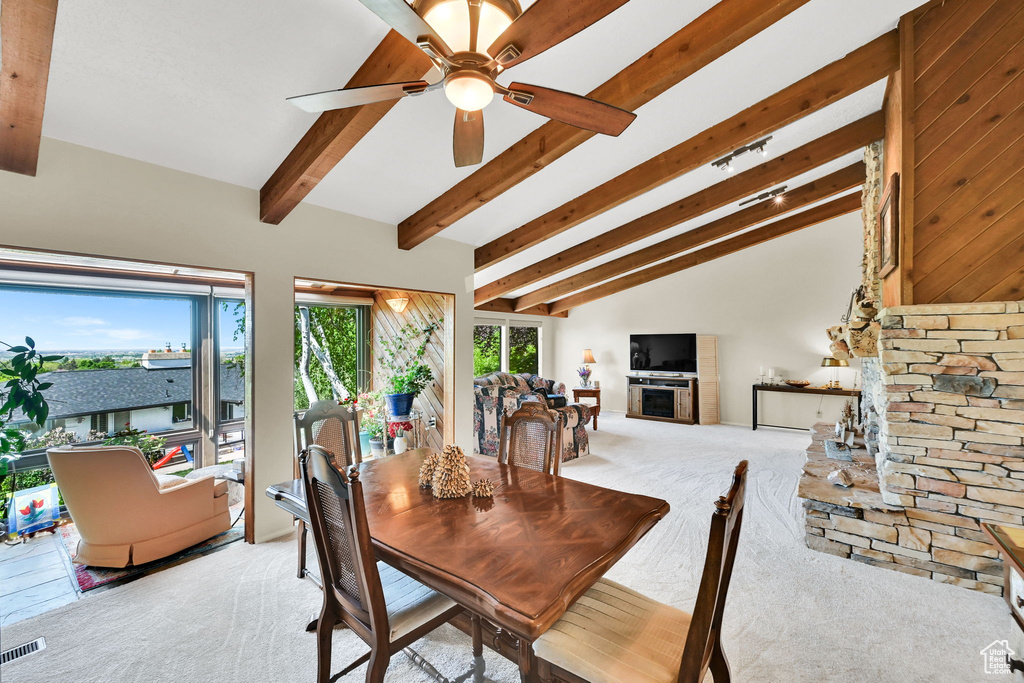 Dining area with light colored carpet and ceiling fan