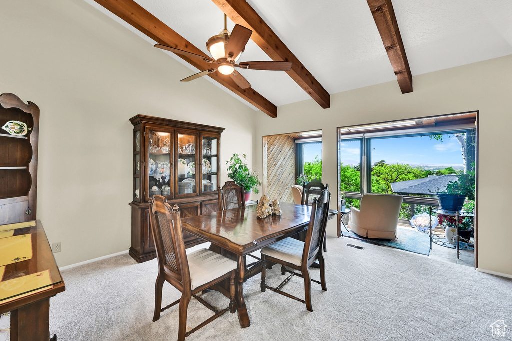 Dining space featuring light carpet, ceiling fan, and baseboards