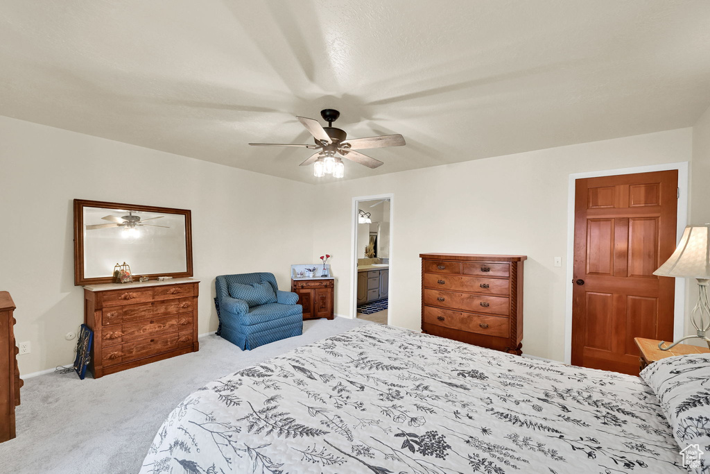 Bedroom with carpet floors, a ceiling fan, connected bathroom, and baseboards