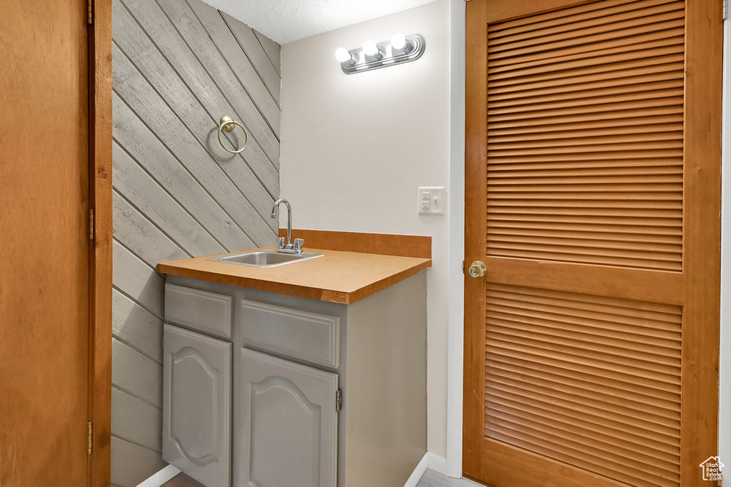 Bathroom featuring wood walls and vanity