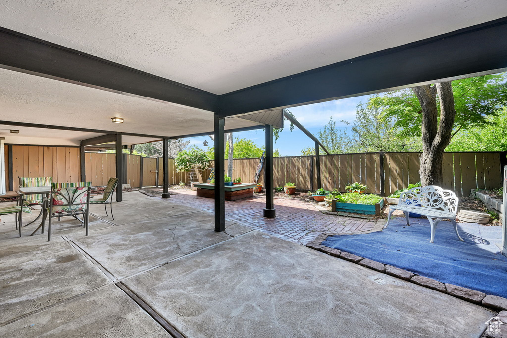 View of patio with a fenced backyard