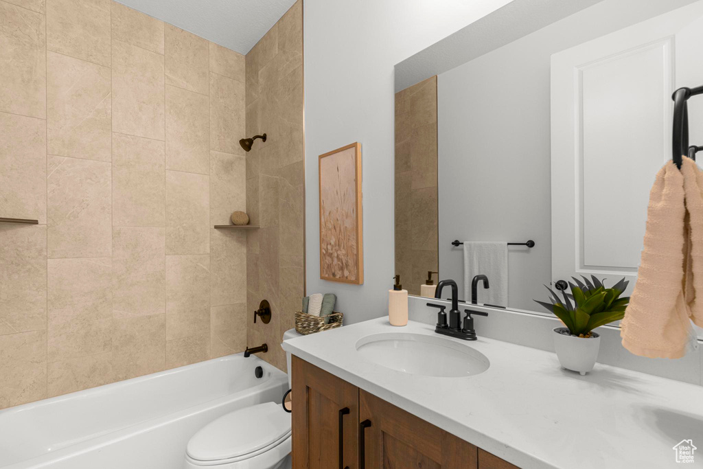 Full bath with vanity, toilet, and bathing tub / shower combination