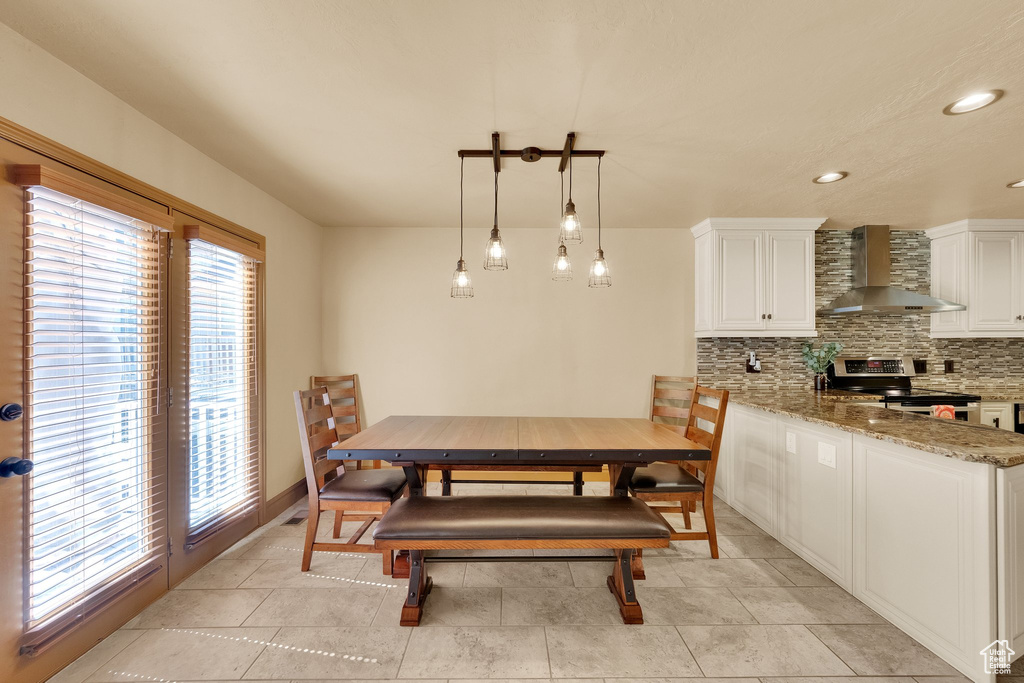 Dining area with recessed lighting and baseboards