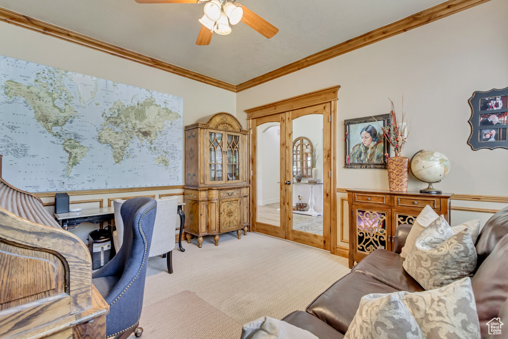 Office with wainscoting, carpet floors, ornamental molding, and ceiling fan