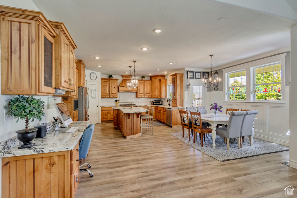 Dining area featuring a chandelier, light wood finished floors, and recessed lighting