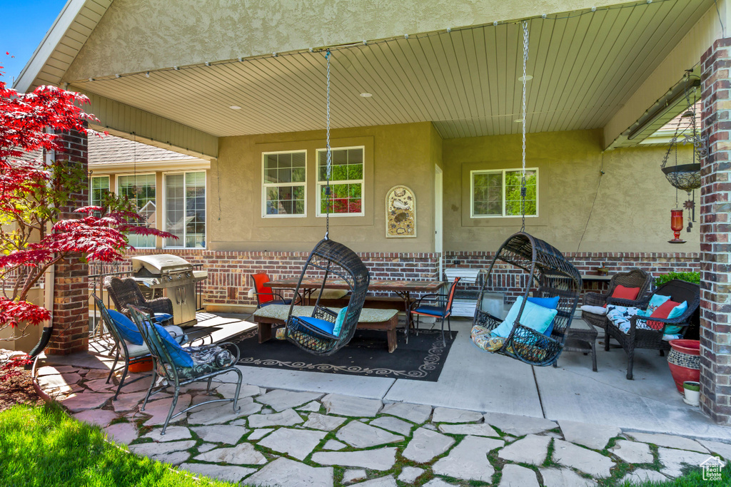 View of patio featuring outdoor lounge area and a grill