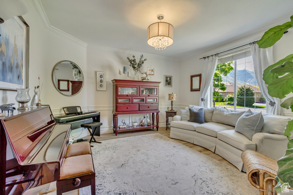 Living room with wood finished floors and crown molding