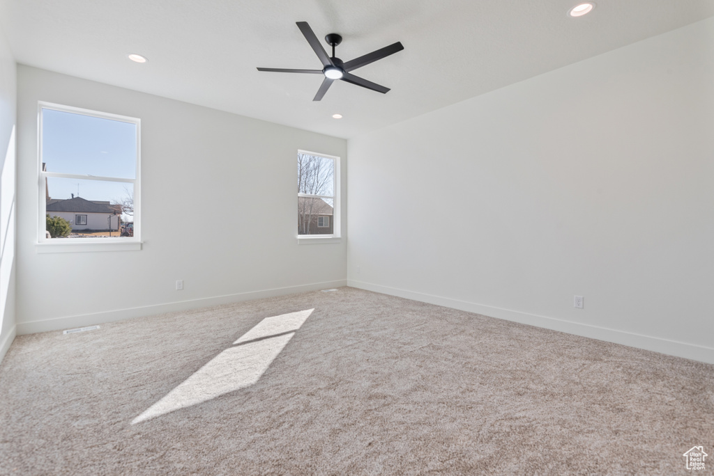 Carpeted spare room with baseboards, recessed lighting, and a ceiling fan