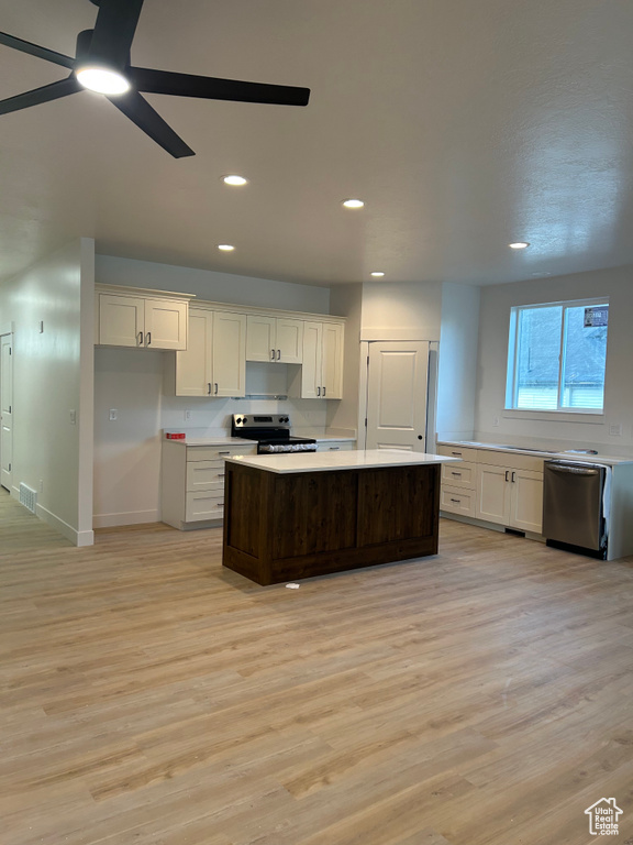 Kitchen featuring stainless steel appliances, light wood-type flooring, ceiling fan, light countertops, and recessed lighting