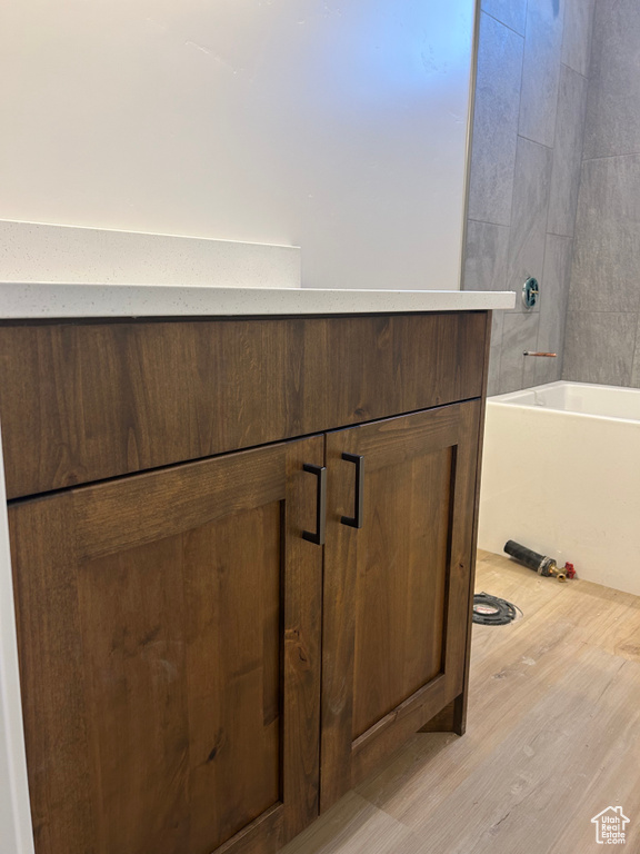 Bathroom view of wood finished floors and vanity