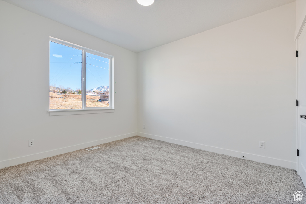 Spare room with carpet floors and baseboards