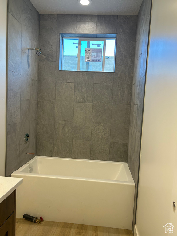 Full bathroom with vanity, shower / bathtub combination, and wood finished floors