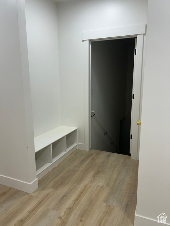 Mudroom with light wood finished floors and baseboards