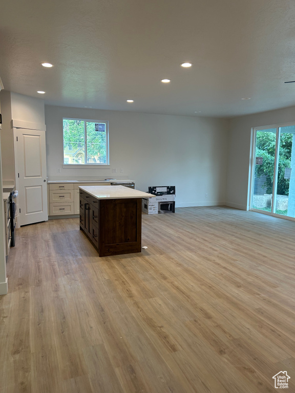 Kitchen featuring plenty of natural light, light countertops, recessed lighting, light wood-type flooring, and a kitchen island