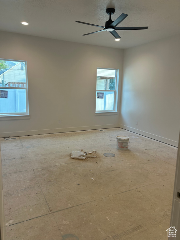 Spare room featuring baseboards and a ceiling fan