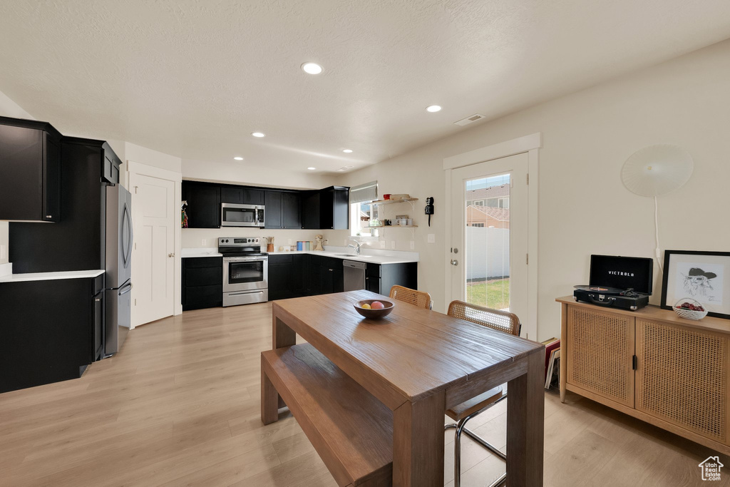 Dining room featuring light wood finished floors and recessed lighting