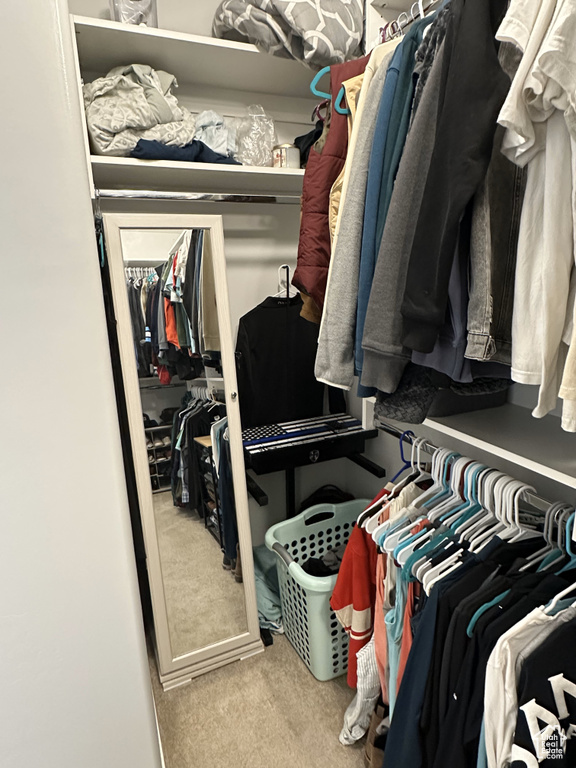 Walk in closet featuring carpet flooring
