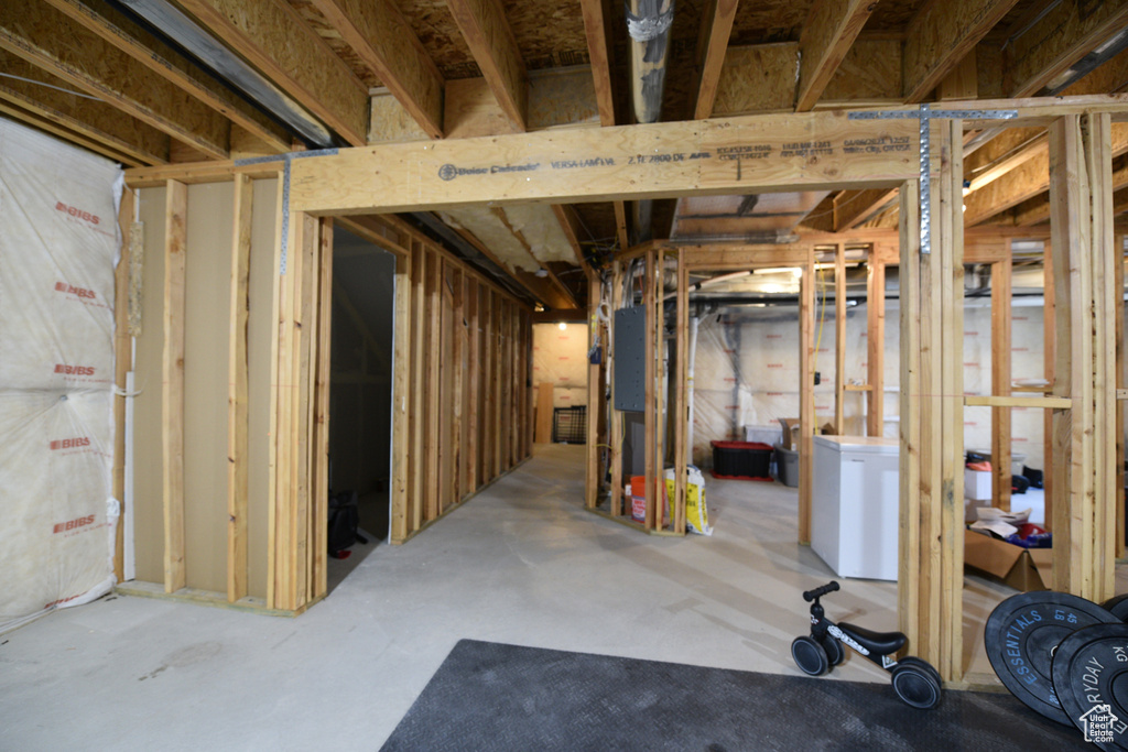 Unfinished below grade area with refrigerator