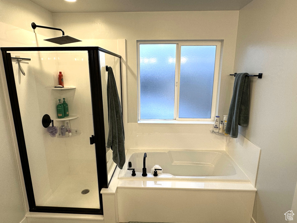 Full bathroom with a shower stall and a bath