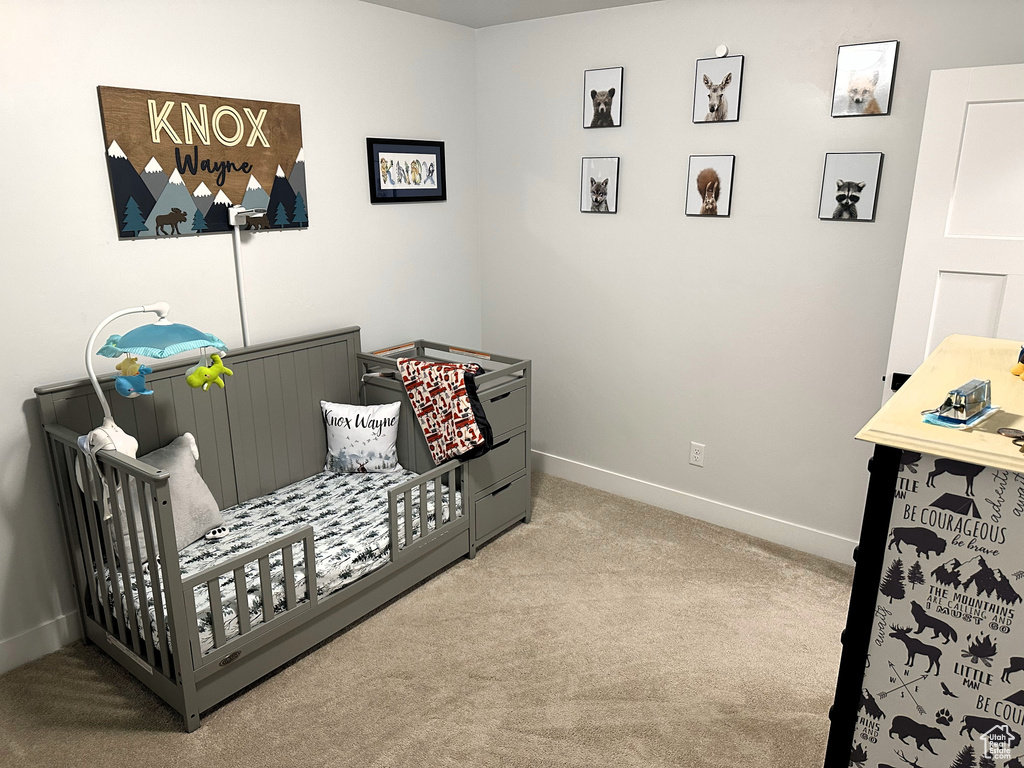 Sitting room featuring carpet flooring and baseboards