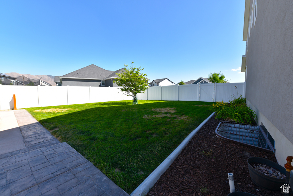 Fenced backyard featuring a residential view and a patio