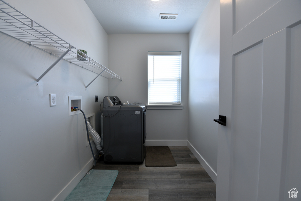 Laundry area with washer / clothes dryer and dark wood-style floors