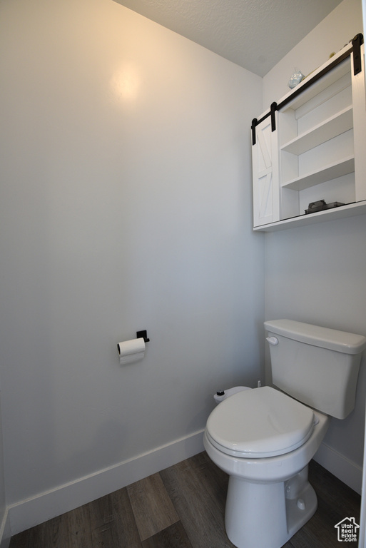 Bathroom featuring baseboards and wood finished floors